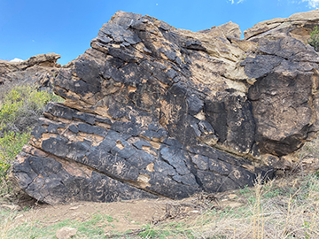 Rock with prehistoric petroglyphs on it.